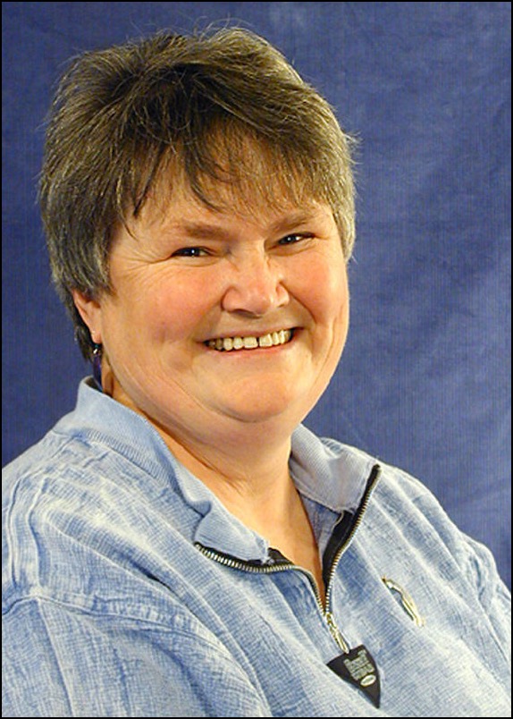 Woman in blue shirt smiling